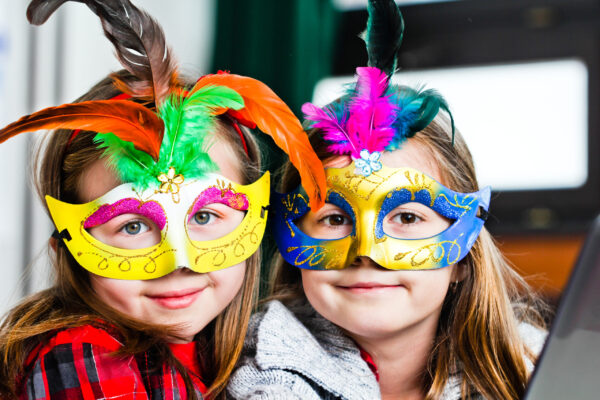 Two funny little girls with masks