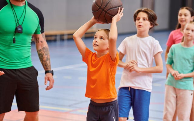 A,Group,Of,Young,Children,Standing,Around,A,Basketball,