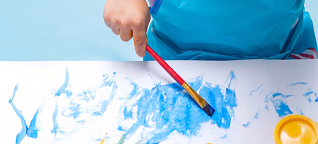 Small child painting a picture