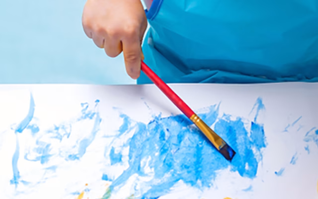 Small child painting a picture