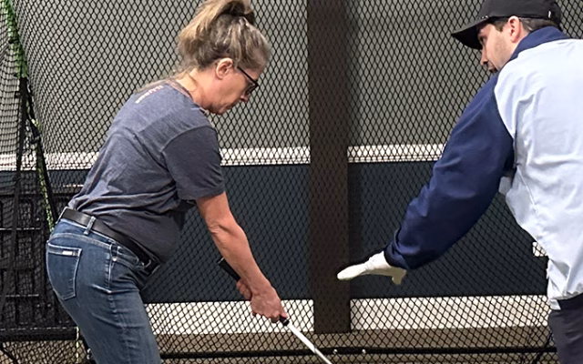Golf pro giving instructions to a golfer in the Gable bar and grill