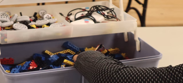 Kids using robot pieces to build different pieces in class
