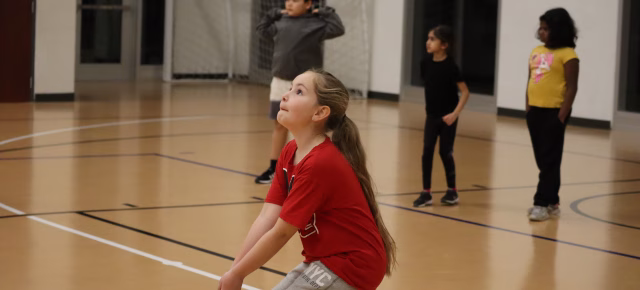 young girl prepares to bump a volleyball