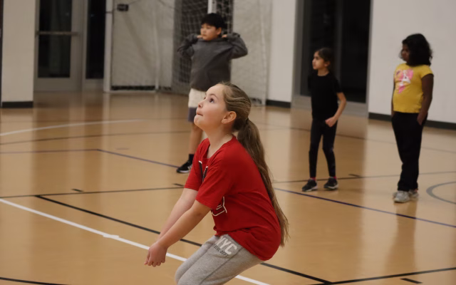 young girl prepares to bump a volleyball