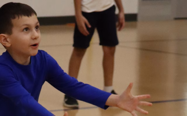 boy bumping volleyball